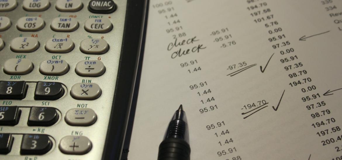 report with a pen and calculator