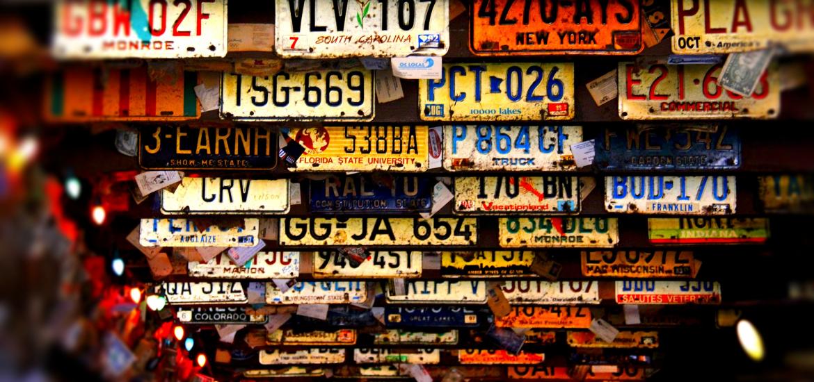 license plates for cars hanging on a ceiling